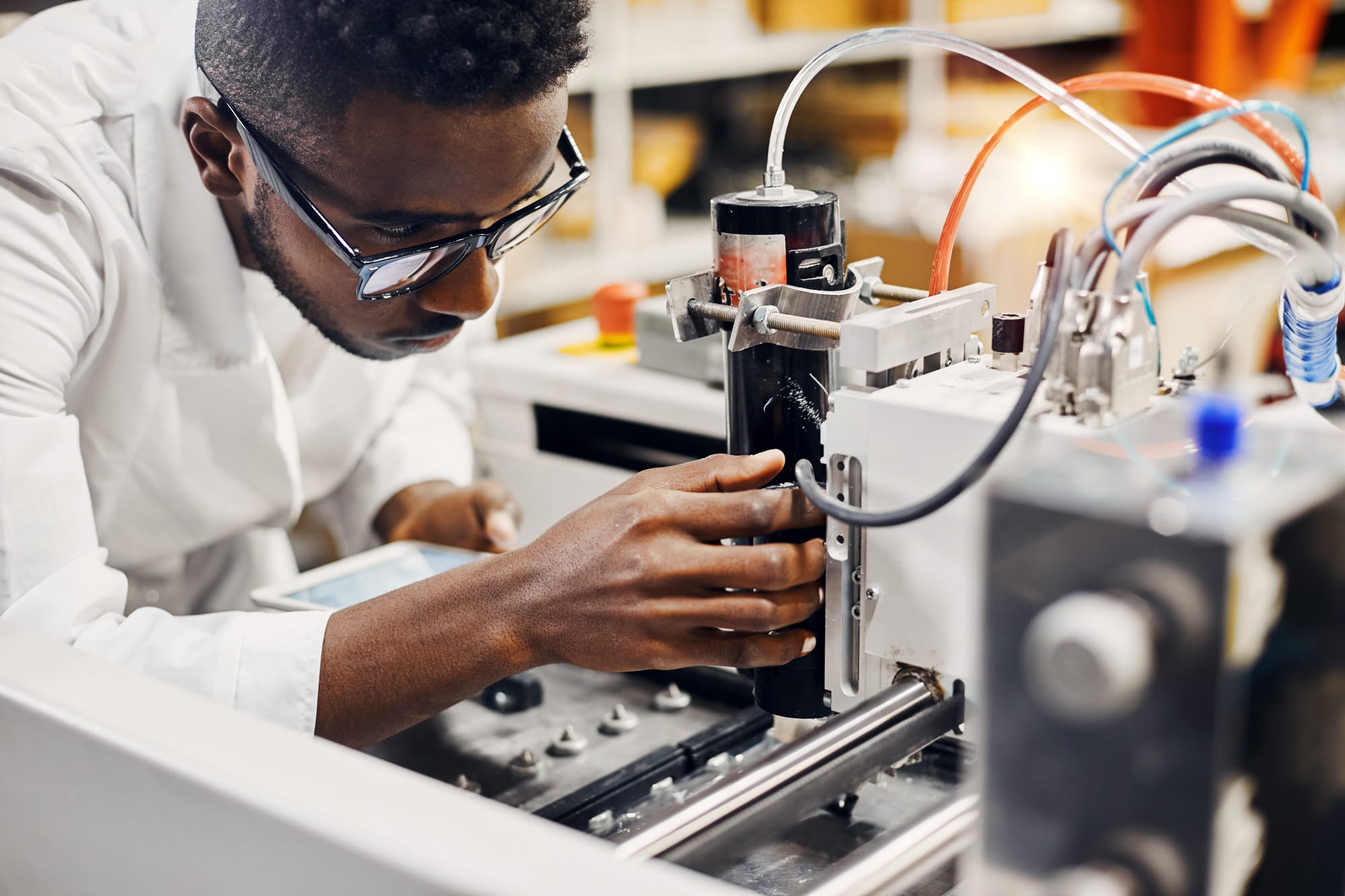 Engineer working with industrial machinery in lab.