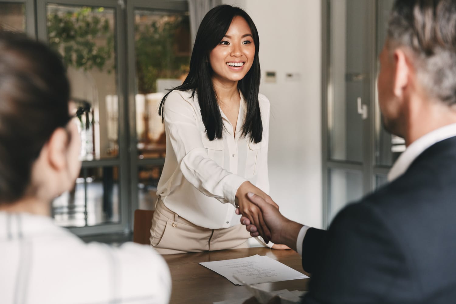 Businesswoman shaking hands during a meeting.